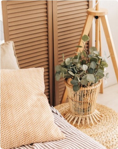 Wooden folding screen, wicker plant stand and textured cushions