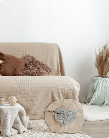 Beige armchair with cushions and a wooden log side table